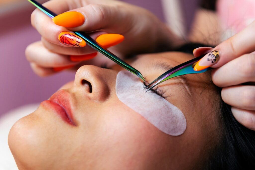 application of eyelash extensions with tweezers